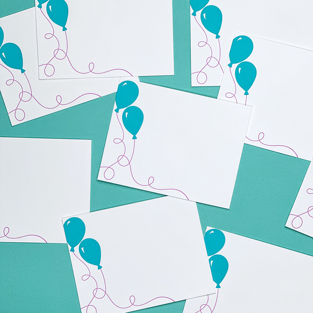 An image of several flat cards featuring balloons